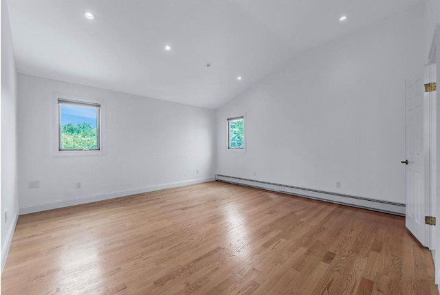 709 Demott Ct, Westbury, NY 11590 - spare room with baseboard heating, light wood-type flooring, lofted ceiling, and recessed lighting