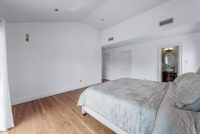 709 Demott Ct, Westbury, NY 11590 - bedroom featuring wood finished floors and high vaulted ceiling