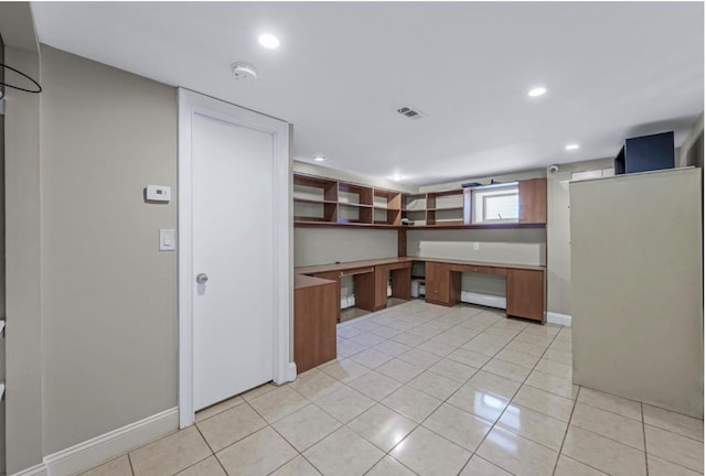 709 Demott Ct, Westbury, NY 11590 - kitchen featuring light tile patterned floors, recessed lighting, and built in desk