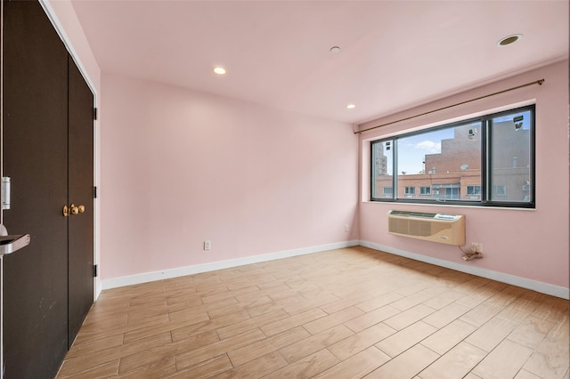 41-38 College Point Blvd Unit 4A, Flushing, NY 11355 - spare room with a wall unit AC, light wood-type flooring, and recessed lighting