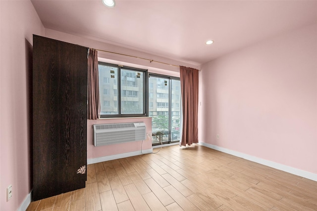 41-38 College Point Blvd Unit 4A, Flushing, NY 11355 - empty room with wood finished floors, recessed lighting, and a wall unit AC