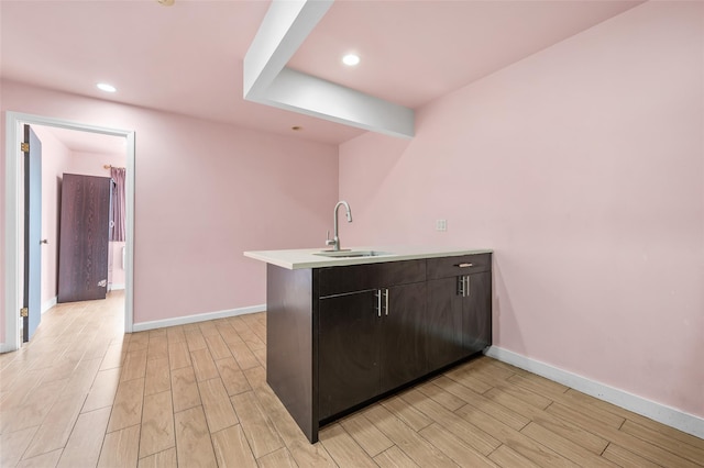41-38 College Point Blvd Unit 4A, Flushing, NY 11355 - kitchen featuring a peninsula, light wood-style floors, light countertops, recessed lighting, and dark brown cabinetry