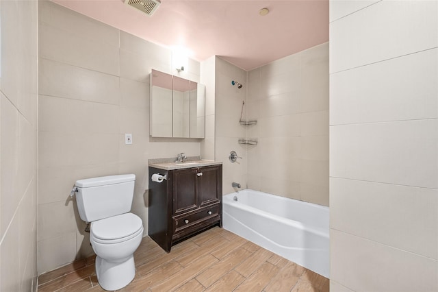 41-38 College Point Blvd Unit 4A, Flushing, NY 11355 - bathroom with wood tiled floors, vanity, tub / shower combination, and tile walls