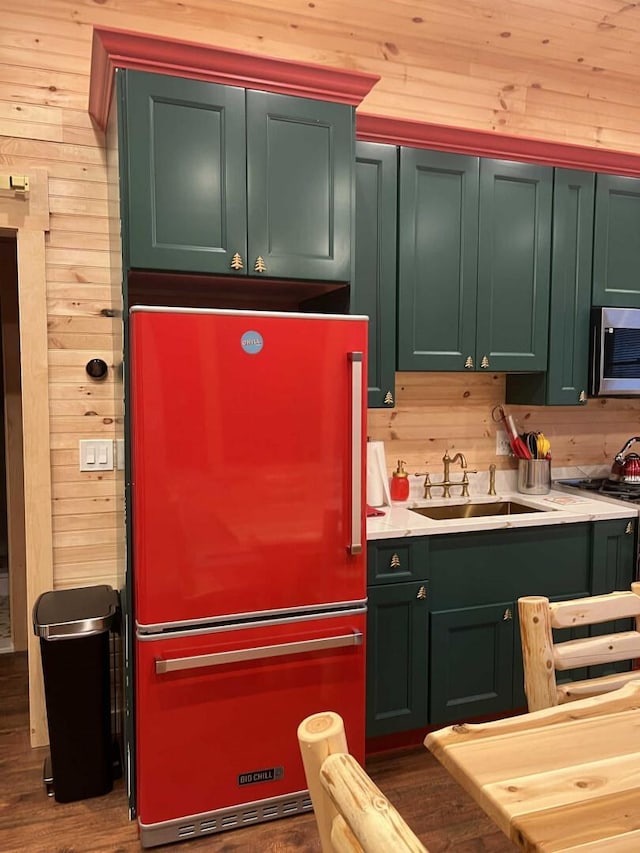 989 Chiloway Rd, Roscoe, NY 13856 - kitchen featuring freestanding refrigerator, stainless steel microwave, wood walls, light countertops, and wood finished floors