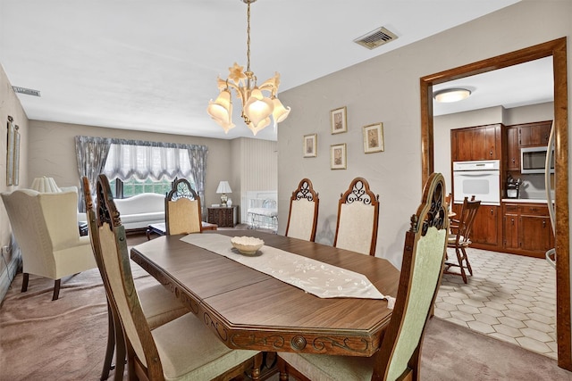 127 Bullet Hole Rd, Carmel, NY 10512 - dining room featuring a chandelier and light colored carpet