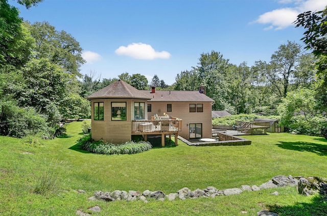 127 Bullet Hole Rd, Carmel, NY 10512 - rear view of house with a wooden deck, a chimney, and a yard