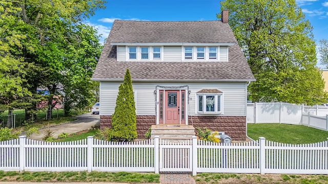26 Rosedale Ave, Freeport, NY 11520 - view of front of house featuring a chimney, roof with shingles, and a fenced front yard