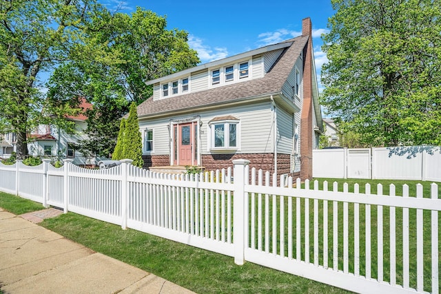 26 Rosedale Ave, Freeport, NY 11520 - bungalow-style home with a fenced front yard, roof with shingles, brick siding, and a chimney