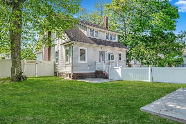 26 Rosedale Ave, Freeport, NY 11520 - view of front of property with a chimney, a gate, a shingled roof, and a patio area