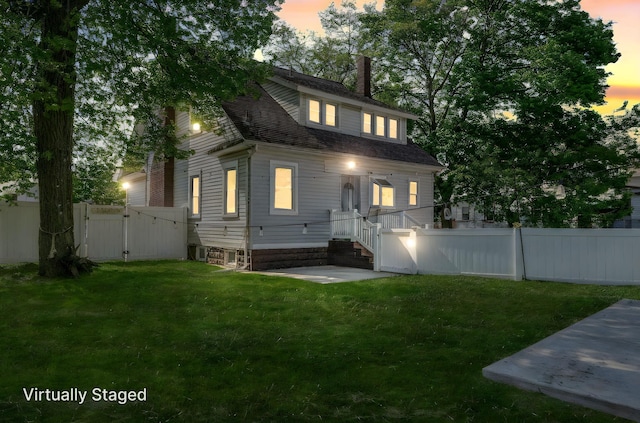 26 Rosedale Ave, Freeport, NY 11520 - rear view of house featuring a chimney and a gate