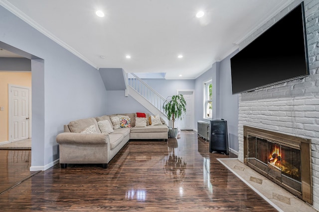 26 Rosedale Ave, Freeport, NY 11520 - living room featuring stairs, wood finished floors, a brick fireplace, recessed lighting, and crown molding