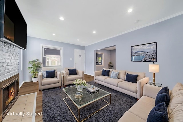 26 Rosedale Ave, Freeport, NY 11520 - living area with light wood-type flooring, a brick fireplace, recessed lighting, and ornamental molding