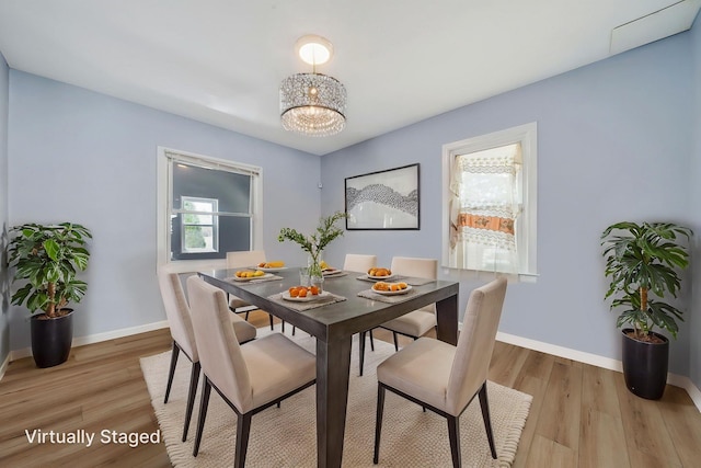 26 Rosedale Ave, Freeport, NY 11520 - dining area featuring light wood finished floors and a chandelier