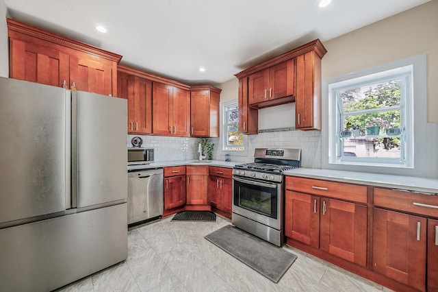 26 Rosedale Ave, Freeport, NY 11520 - kitchen featuring appliances with stainless steel finishes, backsplash, light countertops, plenty of natural light, and recessed lighting