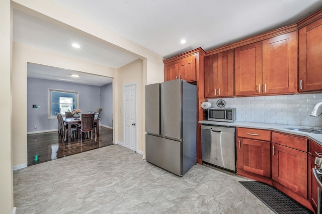 26 Rosedale Ave, Freeport, NY 11520 - kitchen with appliances with stainless steel finishes, light countertops, tasteful backsplash, recessed lighting, and brown cabinetry