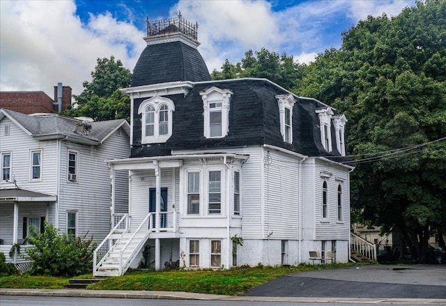 97 E Main St, Middletown, NY 10940 - victorian home featuring mansard roof, roof with shingles, and stairway