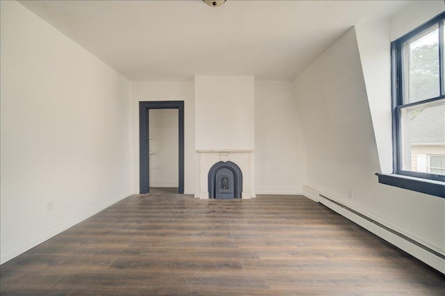 97 E Main St, Middletown, NY 10940 - unfurnished living room featuring baseboard heating, wood finished floors, and a fireplace