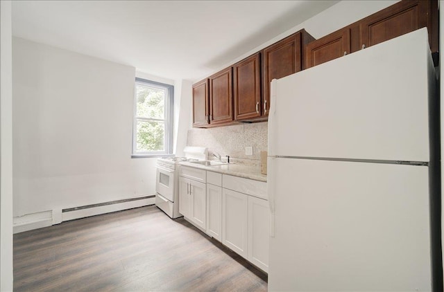 97 E Main St, Middletown, NY 10940 - kitchen with white appliances, a baseboard radiator, light wood-type flooring, light countertops, and backsplash