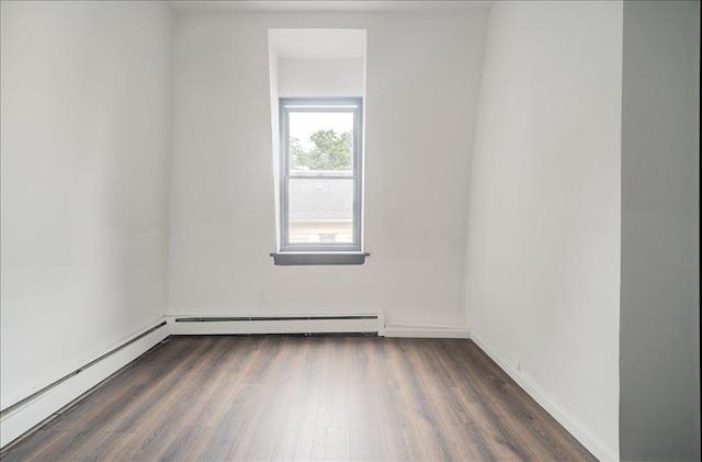 97 E Main St, Middletown, NY 10940 - empty room with wood finished floors, a baseboard heating unit, and a baseboard radiator
