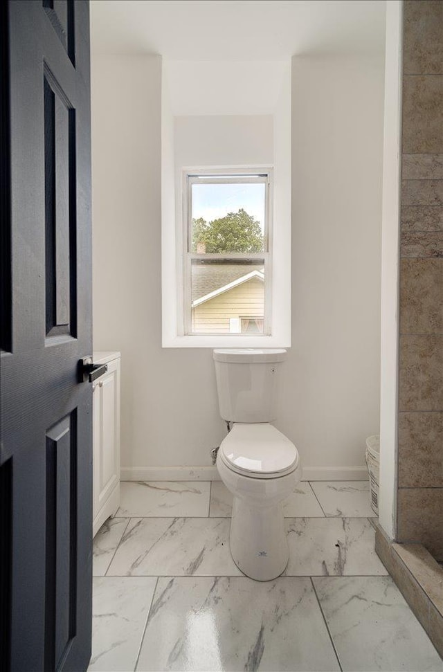 97 E Main St, Middletown, NY 10940 - bathroom featuring marble look tile flooring and toilet
