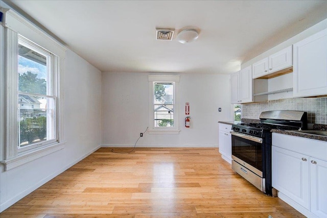 221 E Main St, Middletown, NY 10940 - kitchen featuring gas stove, healthy amount of natural light, light wood finished floors, and dark countertops