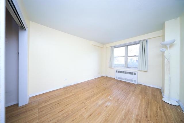 1935 Shore Pkwy Unit 1F, Brooklyn, NY 11214 - unfurnished bedroom with radiator and wood finished floors