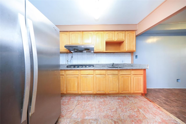 1935 Shore Pkwy Unit 1F, Brooklyn, NY 11214 - kitchen with stainless steel appliances, under cabinet range hood, light stone countertops, backsplash, and light brown cabinets