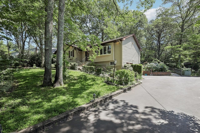65 Winston Dr, Smithtown, NY 11787 - view of front of property with a front yard and driveway