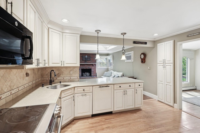 65 Winston Dr, Smithtown, NY 11787 - kitchen with black microwave, a peninsula, tasteful backsplash, light wood-style flooring, and pendant lighting