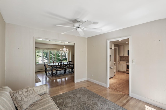 65 Winston Dr, Smithtown, NY 11787 - living area with light wood-type flooring, a chandelier, and ceiling fan