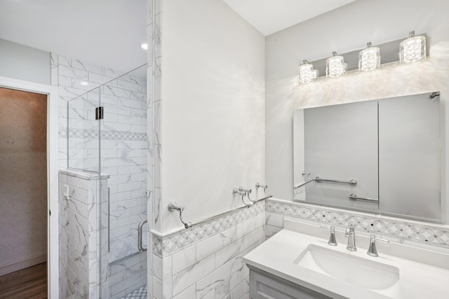 65 Winston Dr, Smithtown, NY 11787 - bathroom featuring vanity, a stall shower, tile walls, and a wainscoted wall