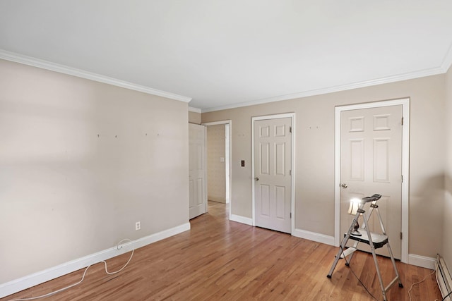 65 Winston Dr, Smithtown, NY 11787 - bedroom with ornamental molding, light wood-style flooring, and a baseboard heating unit