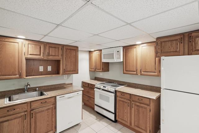 65 Winston Dr, Smithtown, NY 11787 - kitchen featuring white appliances, a paneled ceiling, light tile patterned floors, brown cabinets, and recessed lighting