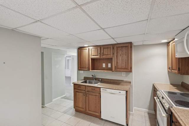 65 Winston Dr, Smithtown, NY 11787 - kitchen featuring white appliances, a paneled ceiling, light tile patterned flooring, brown cabinetry, and recessed lighting