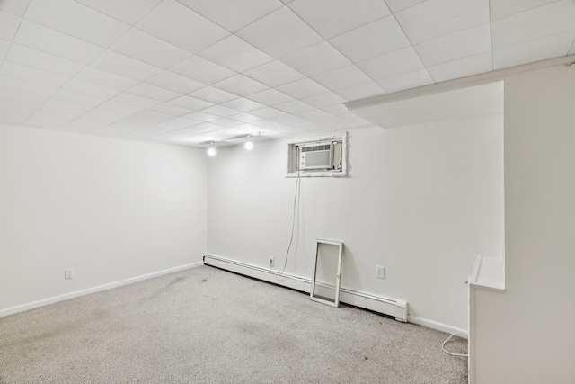 65 Winston Dr, Smithtown, NY 11787 - finished basement with a wall mounted air conditioner, baseboard heating, carpet flooring, and a drop ceiling