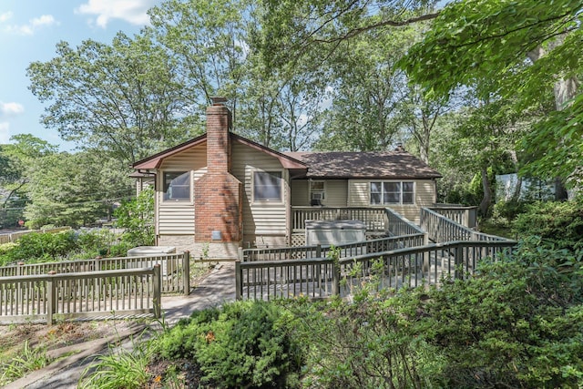 65 Winston Dr, Smithtown, NY 11787 - rear view of house featuring a chimney and a wooden deck