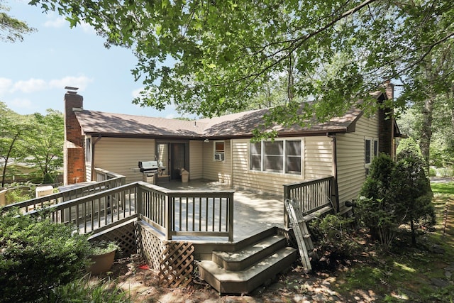 65 Winston Dr, Smithtown, NY 11787 - rear view of house featuring a chimney, a wooden deck, and roof with shingles