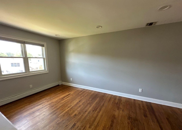 58 Hauppauge Rd, Hauppauge, NY 11788 - empty room with baseboard heating, dark wood-style floors, and recessed lighting