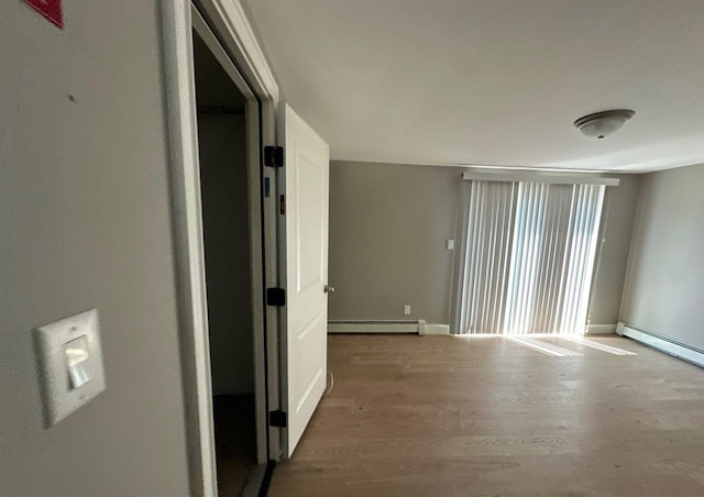 58 Hauppauge Rd, Hauppauge, NY 11788 - unfurnished room with baseboard heating and wood finished floors