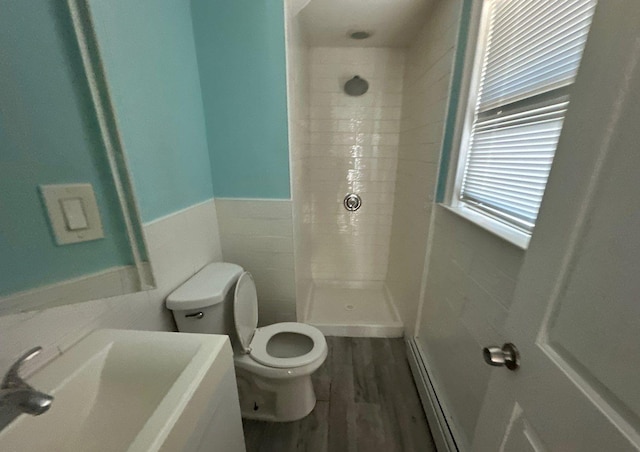 58 Hauppauge Rd, Hauppauge, NY 11788 - full bath featuring tiled shower, vanity, wood finished floors, a wainscoted wall, and tile walls
