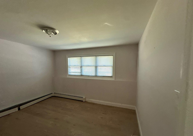 58 Hauppauge Rd, Hauppauge, NY 11788 - unfurnished room featuring a baseboard radiator and wood finished floors