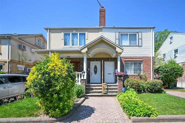 50-40 184th St, Fresh Meadows, NY 11365 - view of front of house with a chimney, brick siding, and a porch