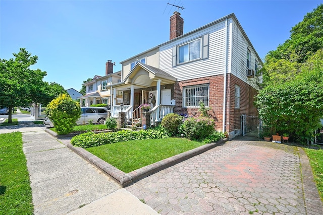 50-40 184th St, Fresh Meadows, NY 11365 - view of front of house with brick siding, a chimney, a gate, a porch, and a front yard