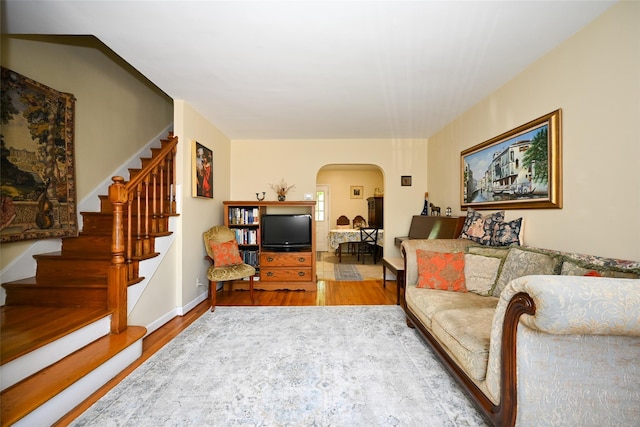 50-40 184th St, Fresh Meadows, NY 11365 - living room featuring wood finished floors, arched walkways, and stairs