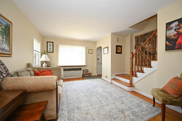 50-40 184th St, Fresh Meadows, NY 11365 - living room with radiator, wood finished floors, arched walkways, and stairway
