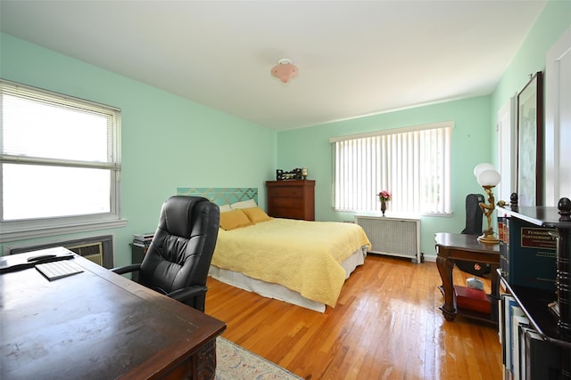 50-40 184th St, Fresh Meadows, NY 11365 - bedroom with radiator heating unit, light wood-style floors, and a desk
