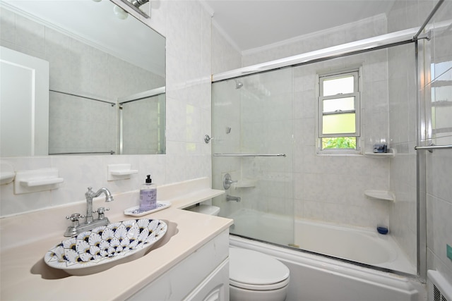 50-40 184th St, Fresh Meadows, NY 11365 - bathroom with crown molding, vanity, combined bath / shower with glass door, and tile walls