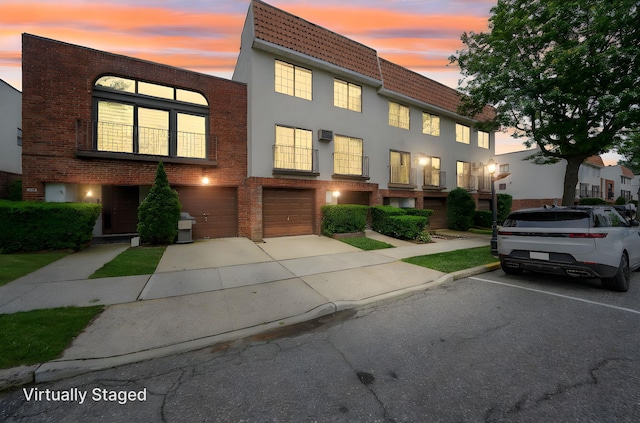 504 Julius Rd Unit 7C, College Point, NY 11356 - view of front of home with an attached garage, concrete driveway, and brick siding