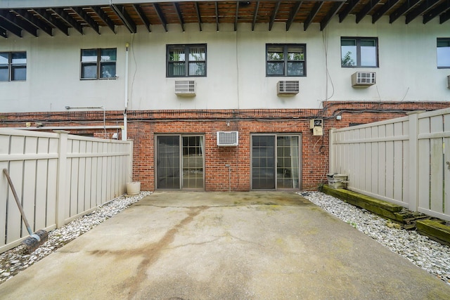 504 Julius Rd Unit 7C, College Point, NY 11356 - rear view of property with brick siding, a patio area, stucco siding, and a wall mounted AC