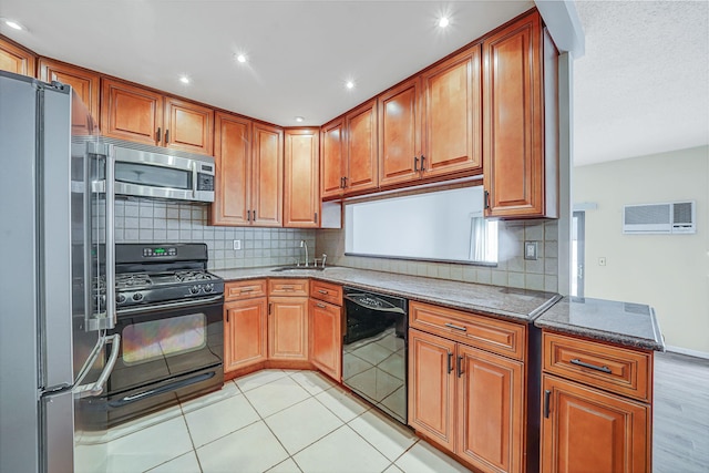 504 Julius Rd Unit 7C, College Point, NY 11356 - kitchen featuring black appliances, decorative backsplash, stone counters, brown cabinetry, and recessed lighting